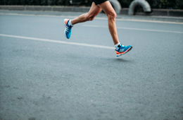260x170_BannerImage_adidas_spring2022 person running in blue adidas shoes on the road, perhaps during a marathon