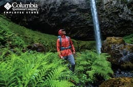 260x170_Columbia_spring2022 Man wearing Columbia Sportswear clothing while on a hike in a green forest