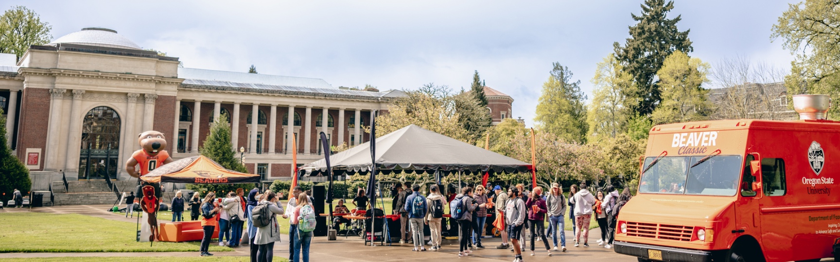 Dam Proud Day celebrations outside at OSU with people gathering to celebrate and OSU food truck