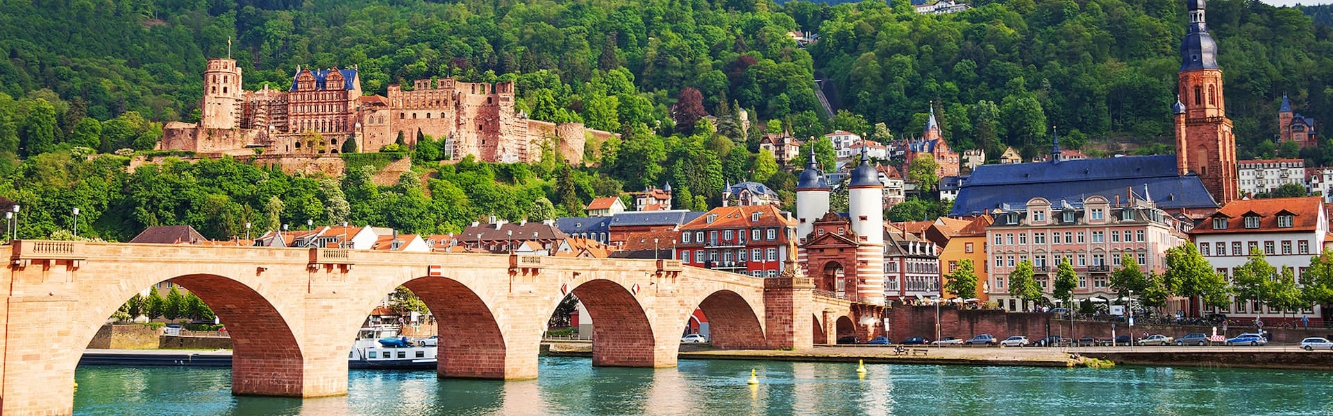 Alte Brucke bridge with river and historic buildings and mountains in the background