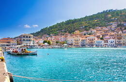 Gytheio coast with bright blue waters, blue skies and colorful buildings on the coast