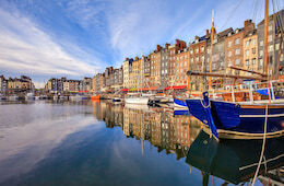 Honfleur's harbor with colorful boats and stacked buildings