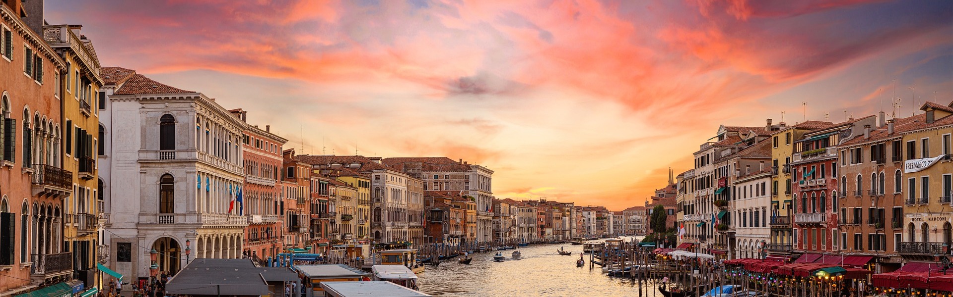 Venice at sunset with canal and buildings lining the water