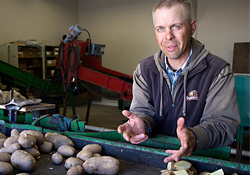 Headshot of Brian Charlton while at work with potatoes on a table