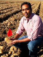 Sagar Sathuvalli outside in a potato field