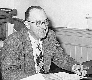 Glenn Willis Holcomb at his desk, in black and white