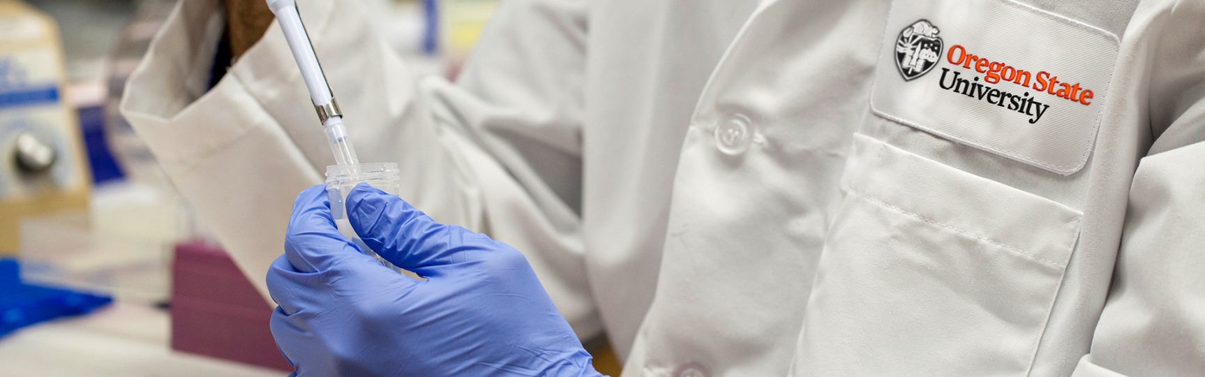 a pharmacist filling a dose into a needle