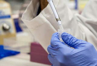 a pharmacist filling a dose into a needle