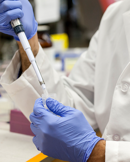 a pharmacist filling a dose into a needle