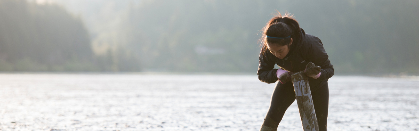 Student collecting samples in water on the oregon coast