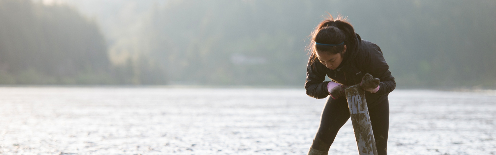 Student collecting samples in water on the oregon coast