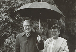 Margaret E. and Thomas R. Meehan in 1980 walking under an umbrella, a common site to see on campus