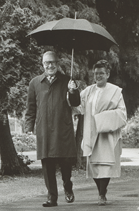 Margaret E. and Thomas R. Meehan in 1980 walking under an umbrella, a common site to see on campus