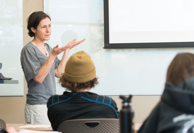 Rebecca Webb speaking in front of a classroom