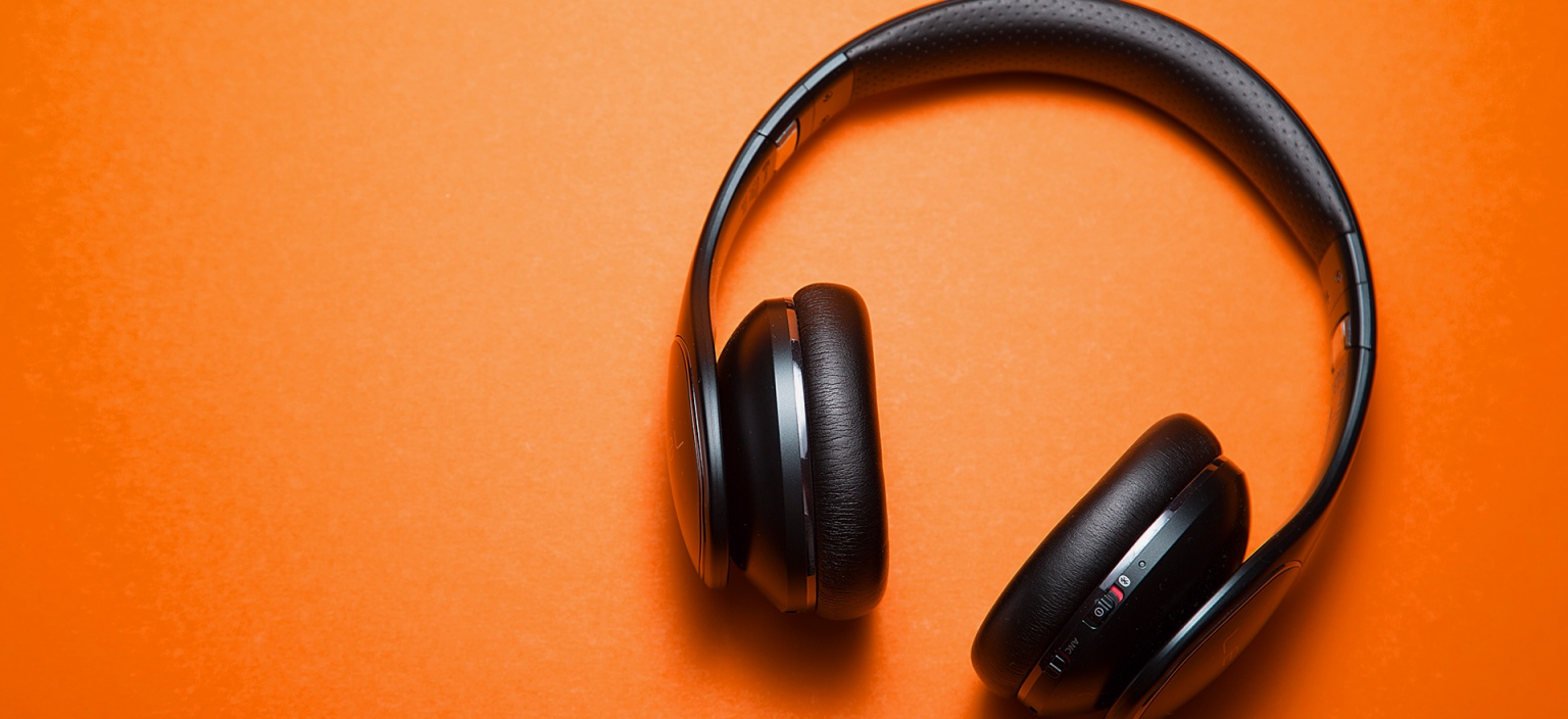 Black headphones on an orange background