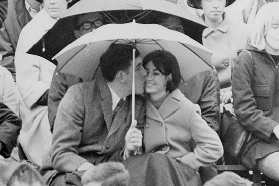 Photo from the 1967 OSU yearbook featuring students sharing a kiss at a football game.