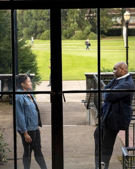 Dorian Smith talking with an OSU student, shot taken from inside looking out of a window of them talking outside