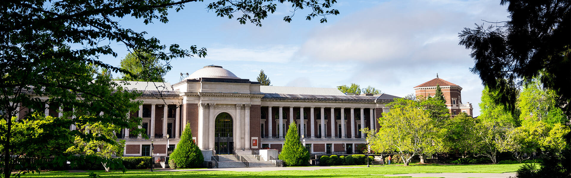 The memorial union on a clear blue day with branches framing the left and right side.