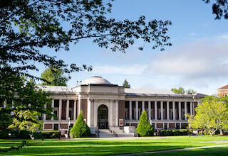 The memorial union on a clear blue day with branches framing the left and right side.