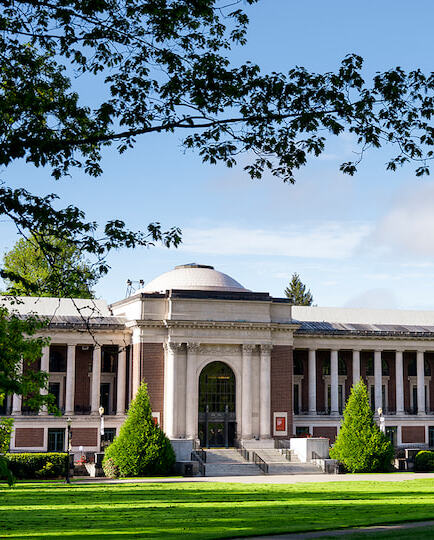 The memorial union on a clear blue day with branches framing the left and right side.