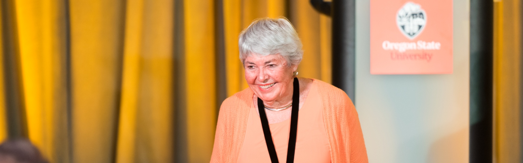 Peggy Wood walking off stage and smiling.