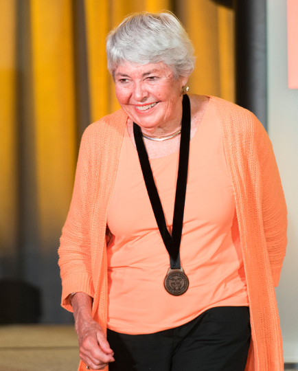 Peggy Wood walking off stage and smiling.