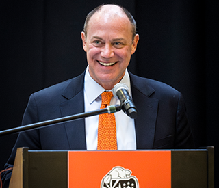 Shawn Scoville smiling at a podium