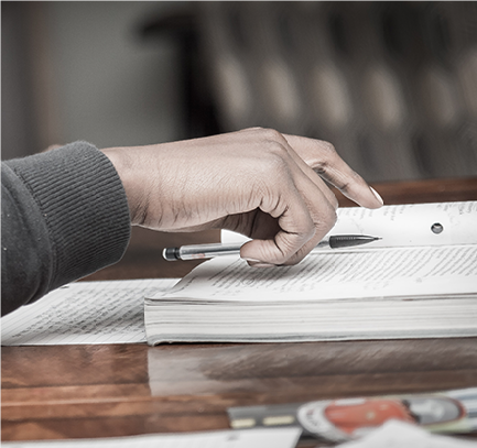 Notebook with someone holding a mechanical pencil over it