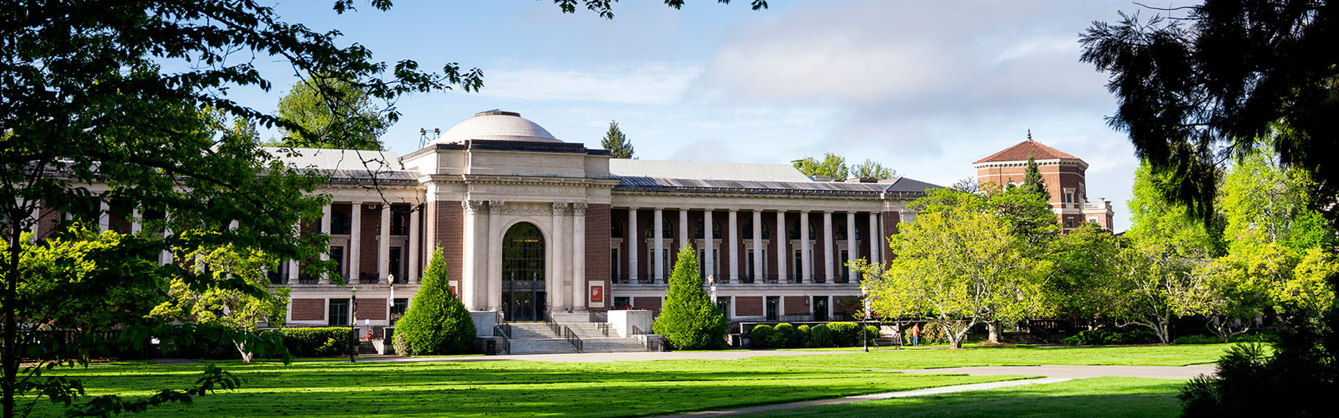 The memorial union on a clear blue day with branches framing the left and right side.