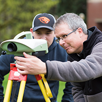 Photo of Professor Chris Parrish working with a student