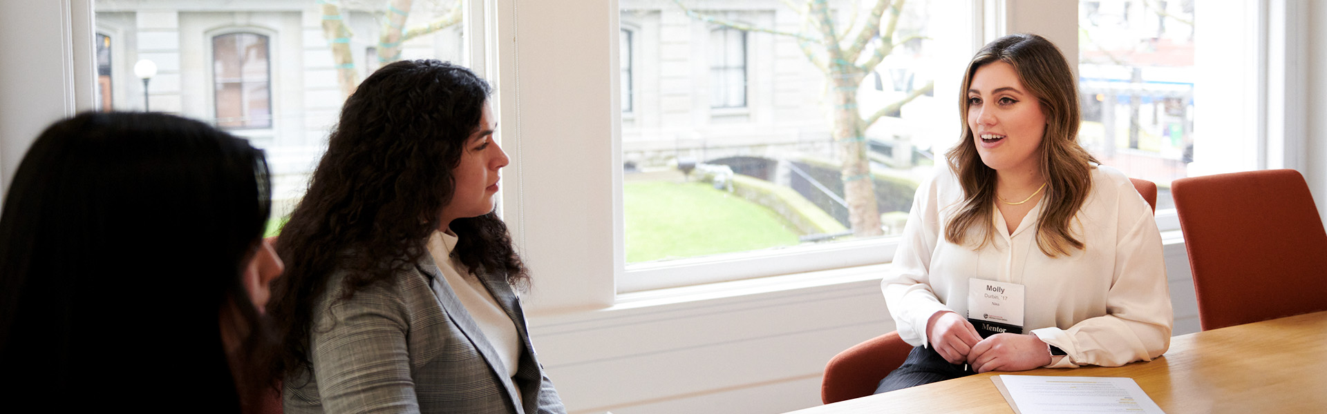 A mentor talking to two mentees