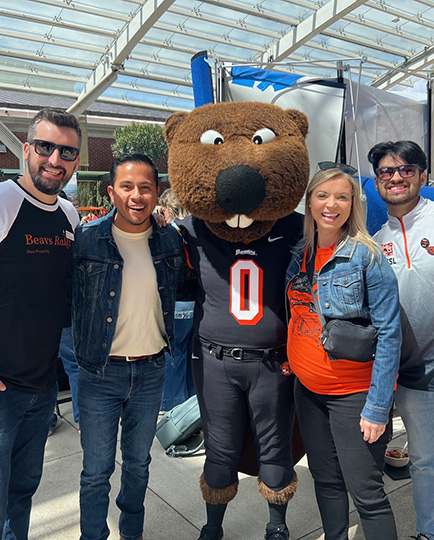 Group of people pose with Benny the Beaver