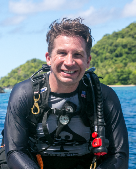 Derek Abbey smiling in scuba gear