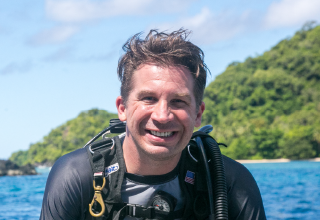 Derek Abbey smiling in scuba gear