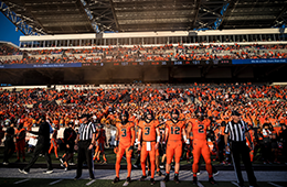 EventThumbnail_BeaverBowl_Placeholder OSU Beaver football players in orange uniforms standing on the sidelines ready for action