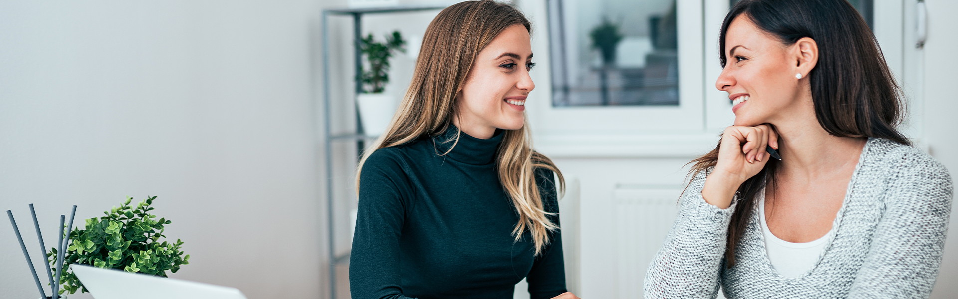 Sitefinity_Banner_1920x600_Career1-25 Two smiling women at a desk