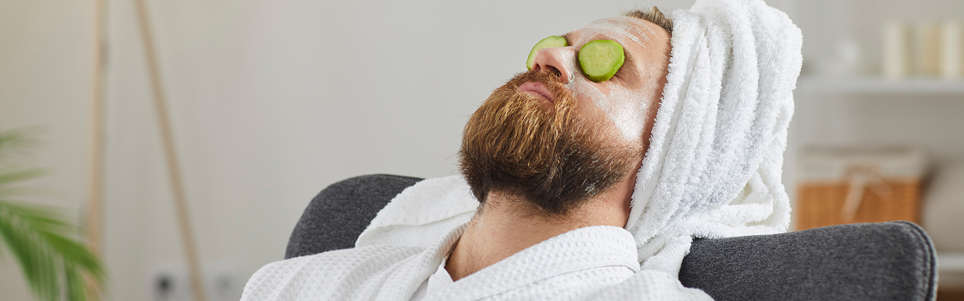 A person in a spa setting with cucumbers over the eyes.