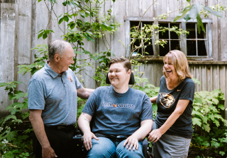 Kolbey Bonin with Deb and Tim Tyler laughing together.
