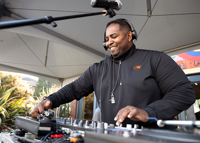 A smiling DJ working his dials.