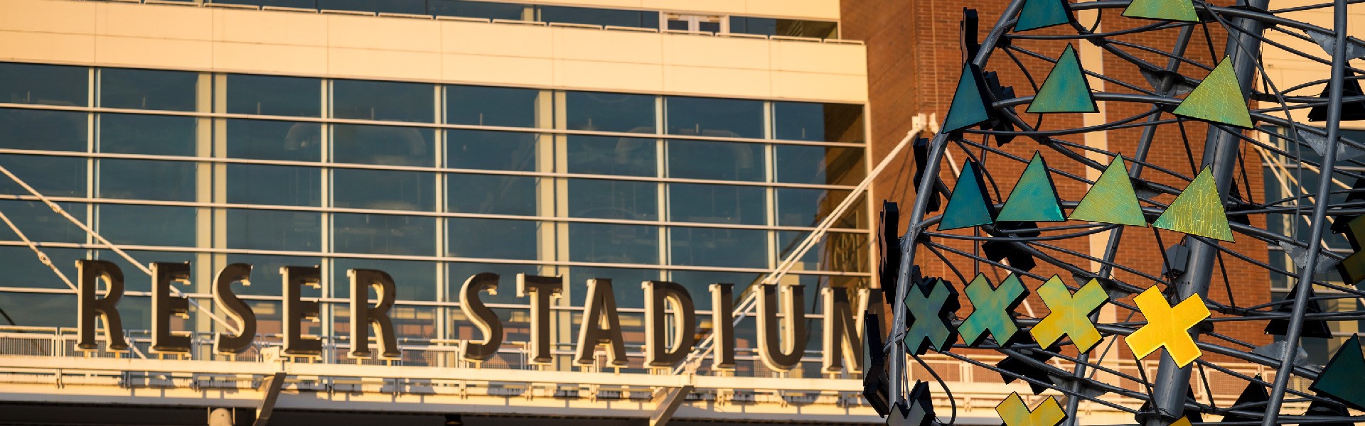 Photo of the front of Reser Stadium with the football sculpture on the right side