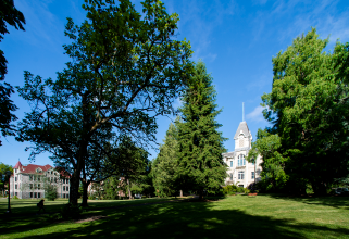 Scenic view of grass and Benton building