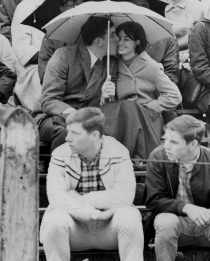 1967 photo that's black and white of a couple sharing an umbrella